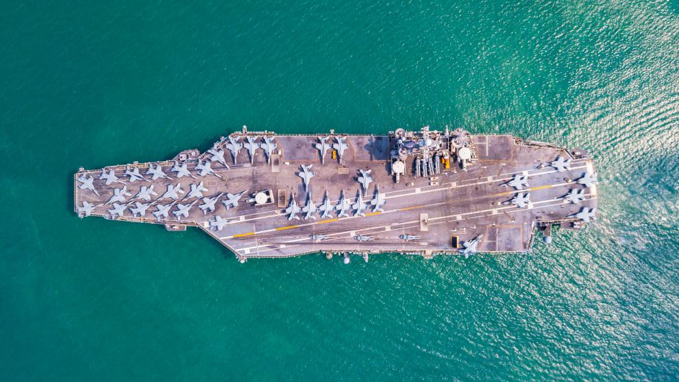 A view above of an aircraft carrier on a ship.