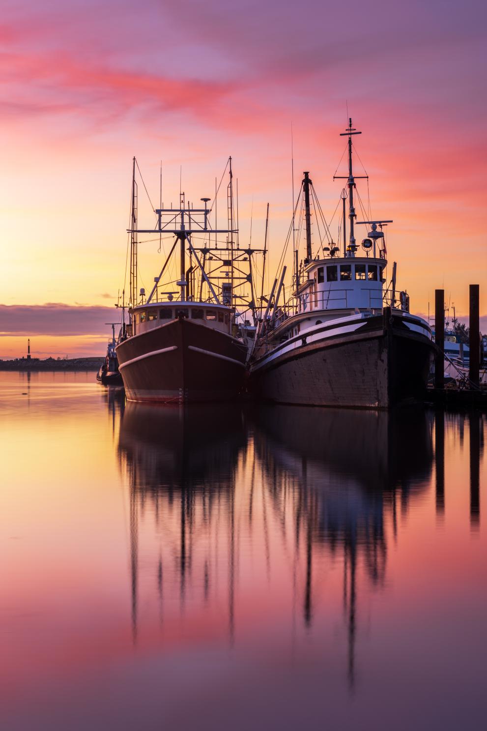 Image of fishing boats at sunset.